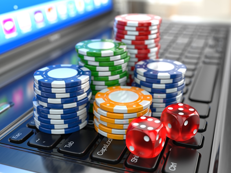 9913921-virtual-casino-online-gambling-laptop-with-dice-and-chips